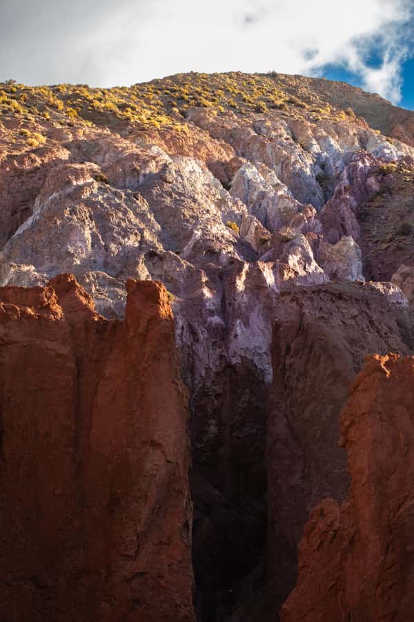 San Pedro de Atacama: Rainbow Valley & Hierbas Buenas Tour - Walking through the colored valley